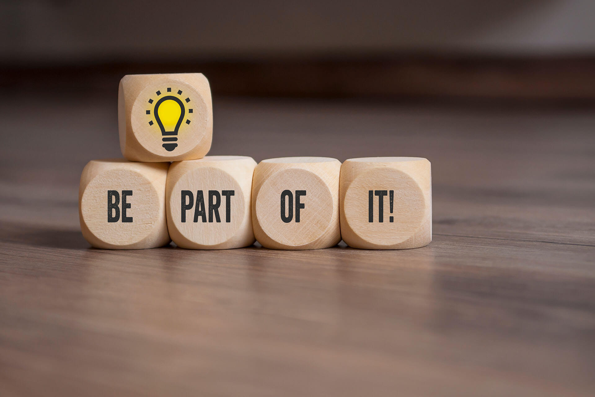 Wooden blocks spelling 'Be part of it'